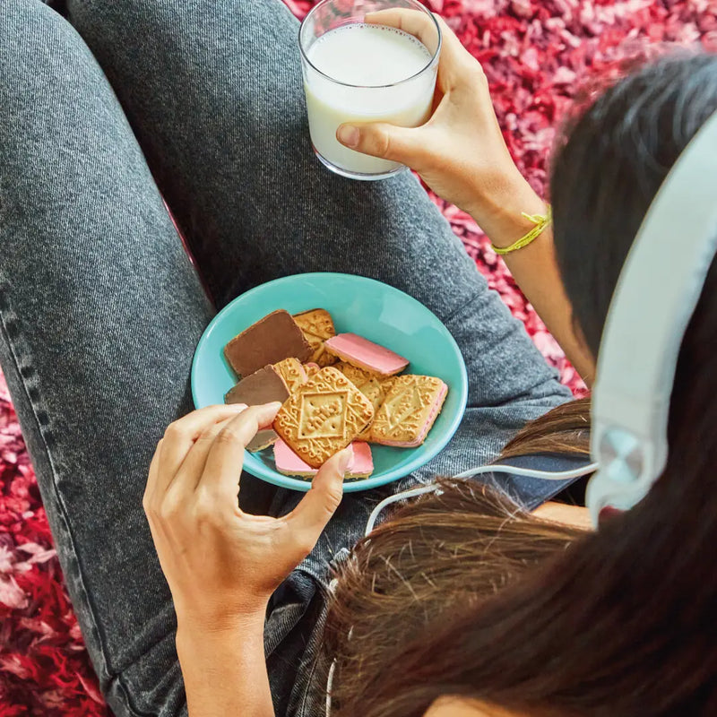 person eating Chiky strawberry and chocolate flavor